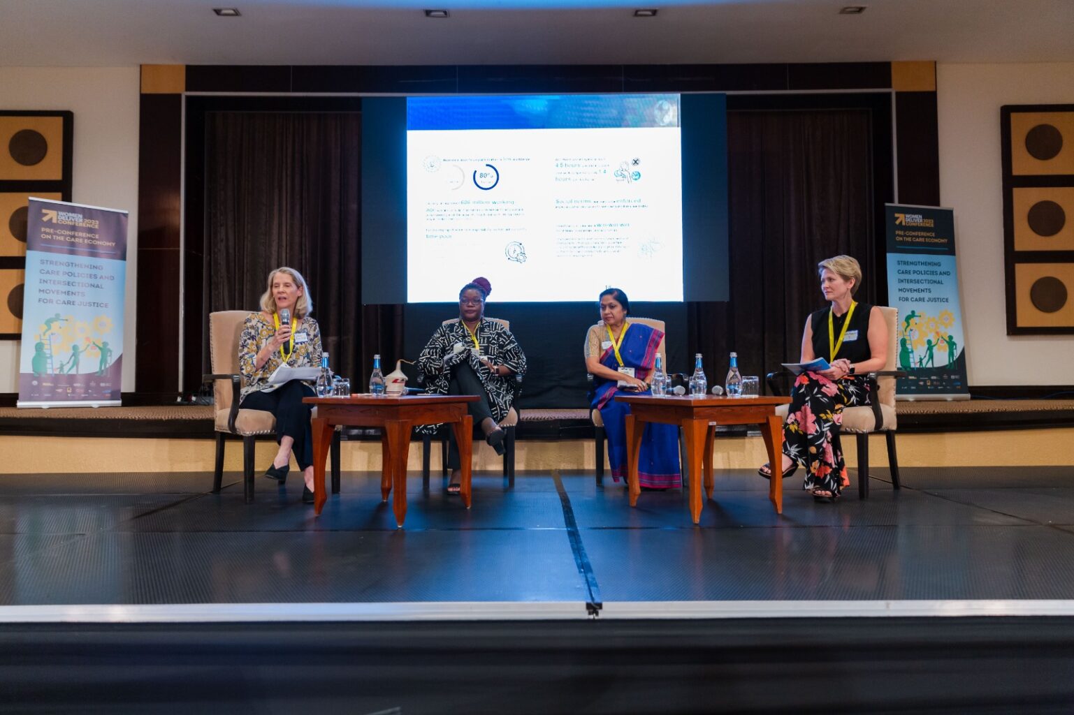 Pre-conference panel with four women sitting on stage.