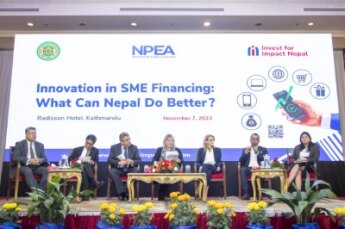Panelists sitting on stage with presentation in background Innovation in SME Financing: What Can Nepal Do Better?