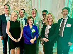 Cindy Shepherd with Cadmus Executives smiling for picture at the NVTC awards