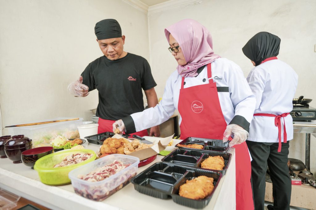 People assembling prepackaged meals