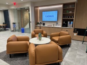 Four comfortable chairs set around a small table in the lobby of the Cadmus Arlington office